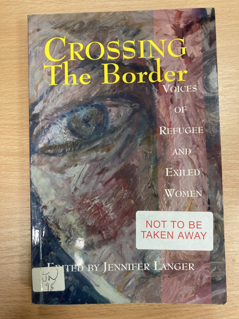 Front cover of Crossing the Border. Includes a painted face with a large blue eye.