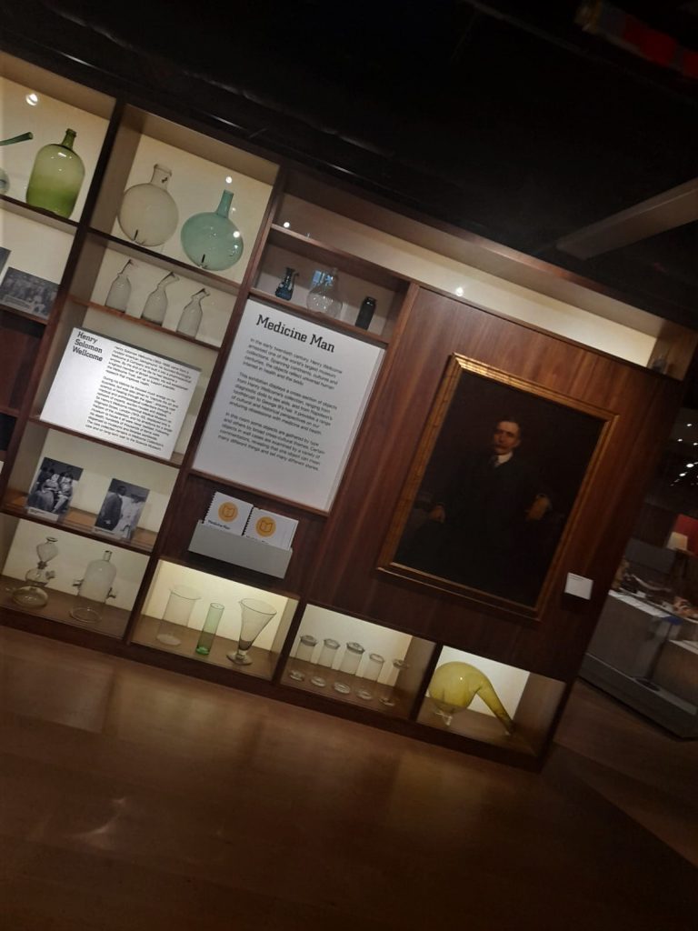 Display including portrait o Henry Wellcome, text headed Medicine Man and various pieces of scientific glassware
